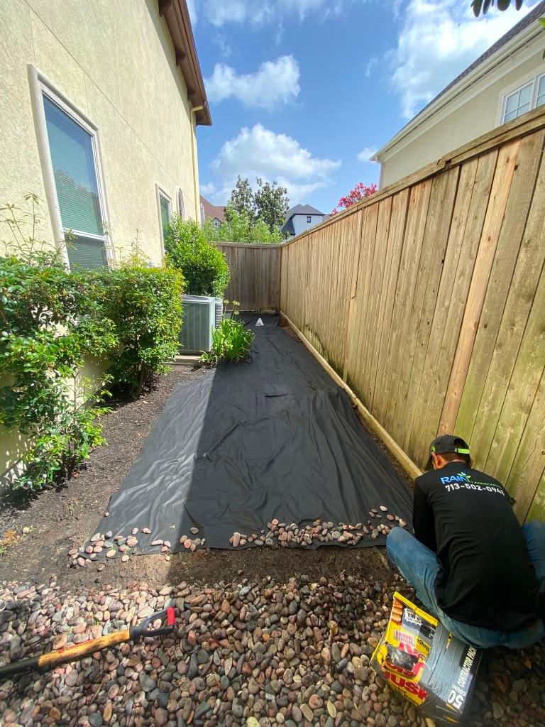 Decorative stone landscaping installed around a residential property